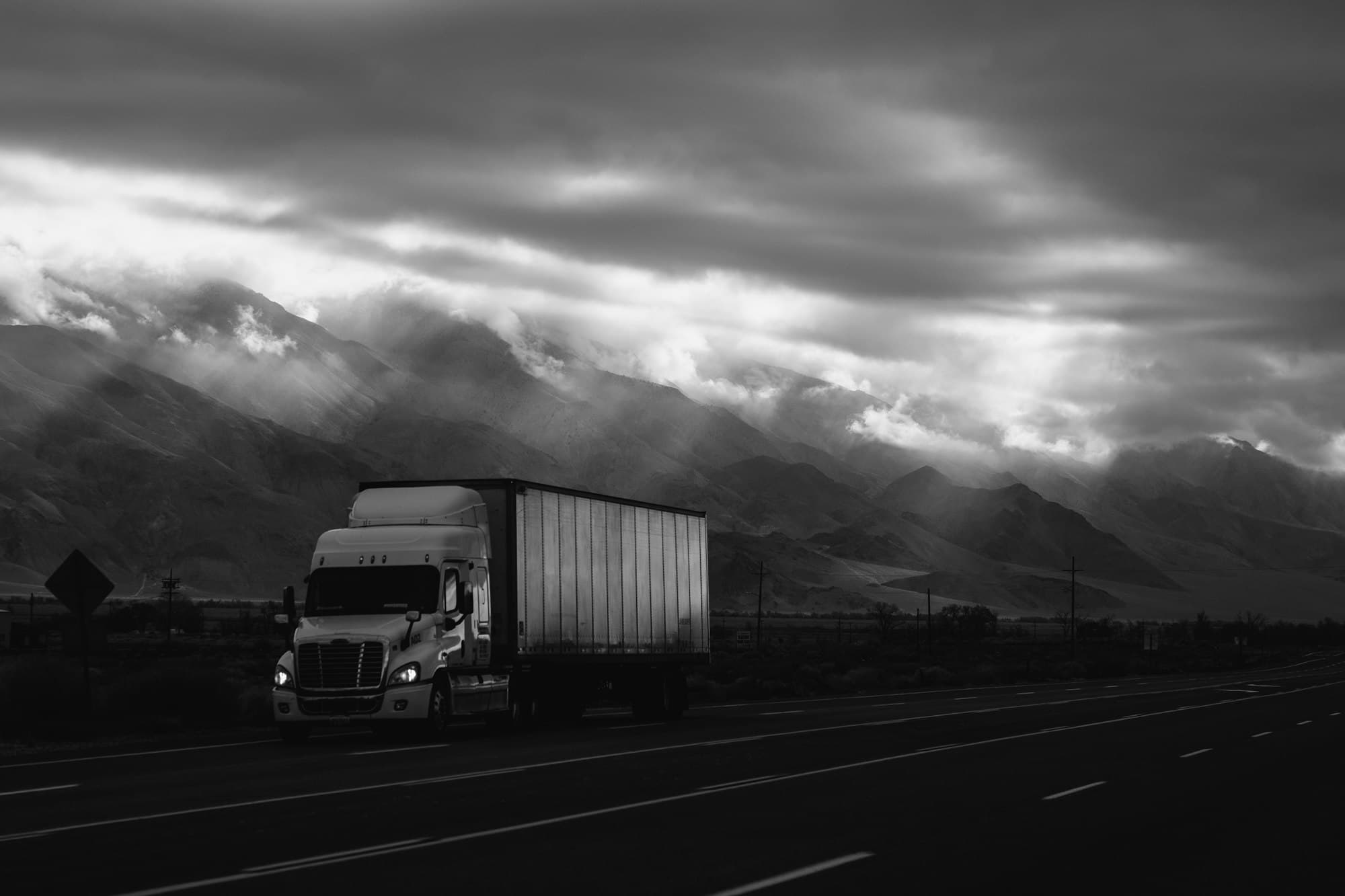 Freight truck driving through mountain terrain