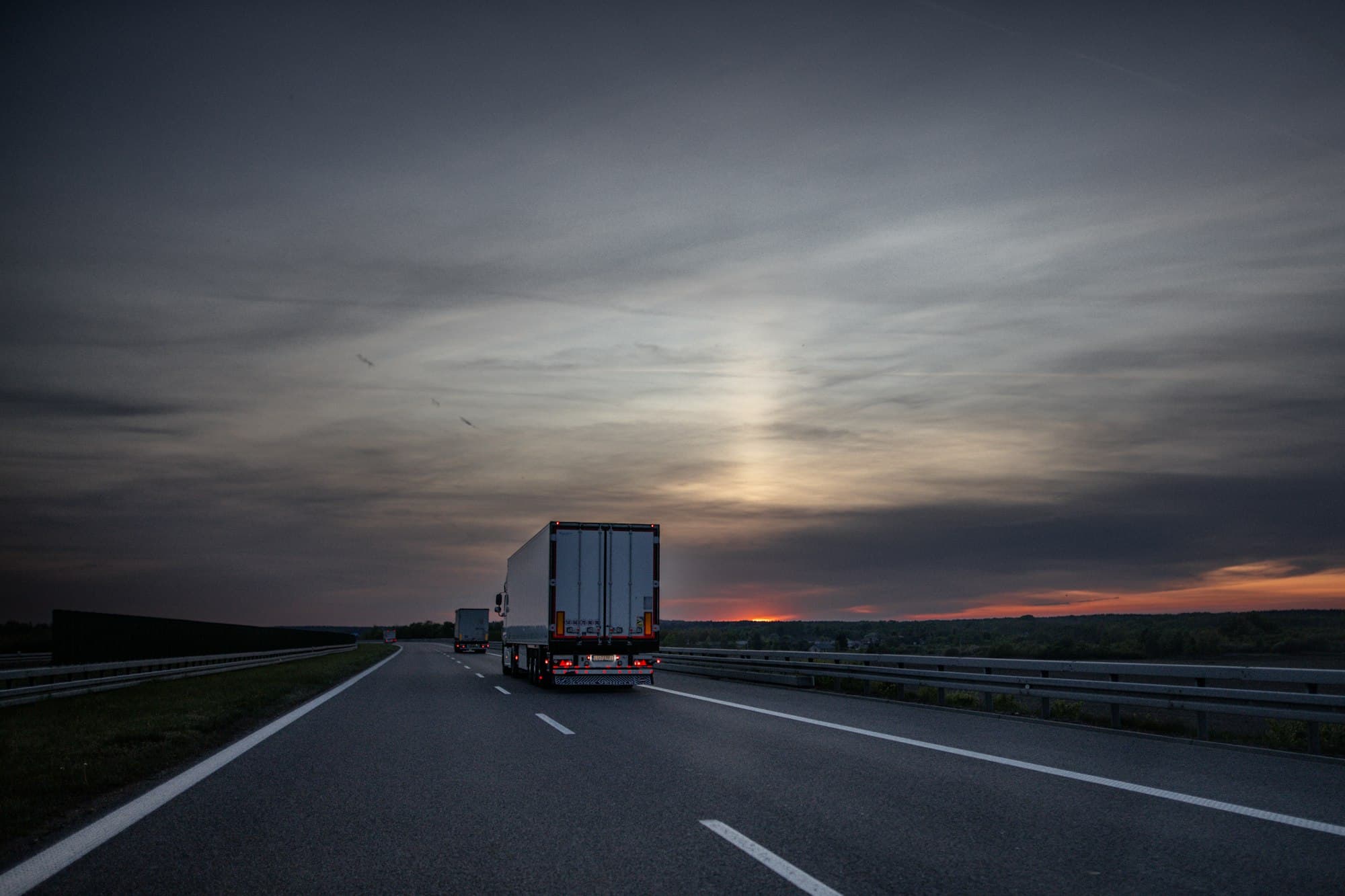 Freight truck driving on a UK motorway at dusk